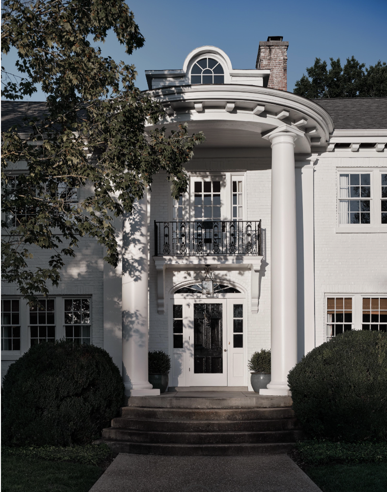 Beautiful white home with 2 story column on the front create beautiful curb appeal