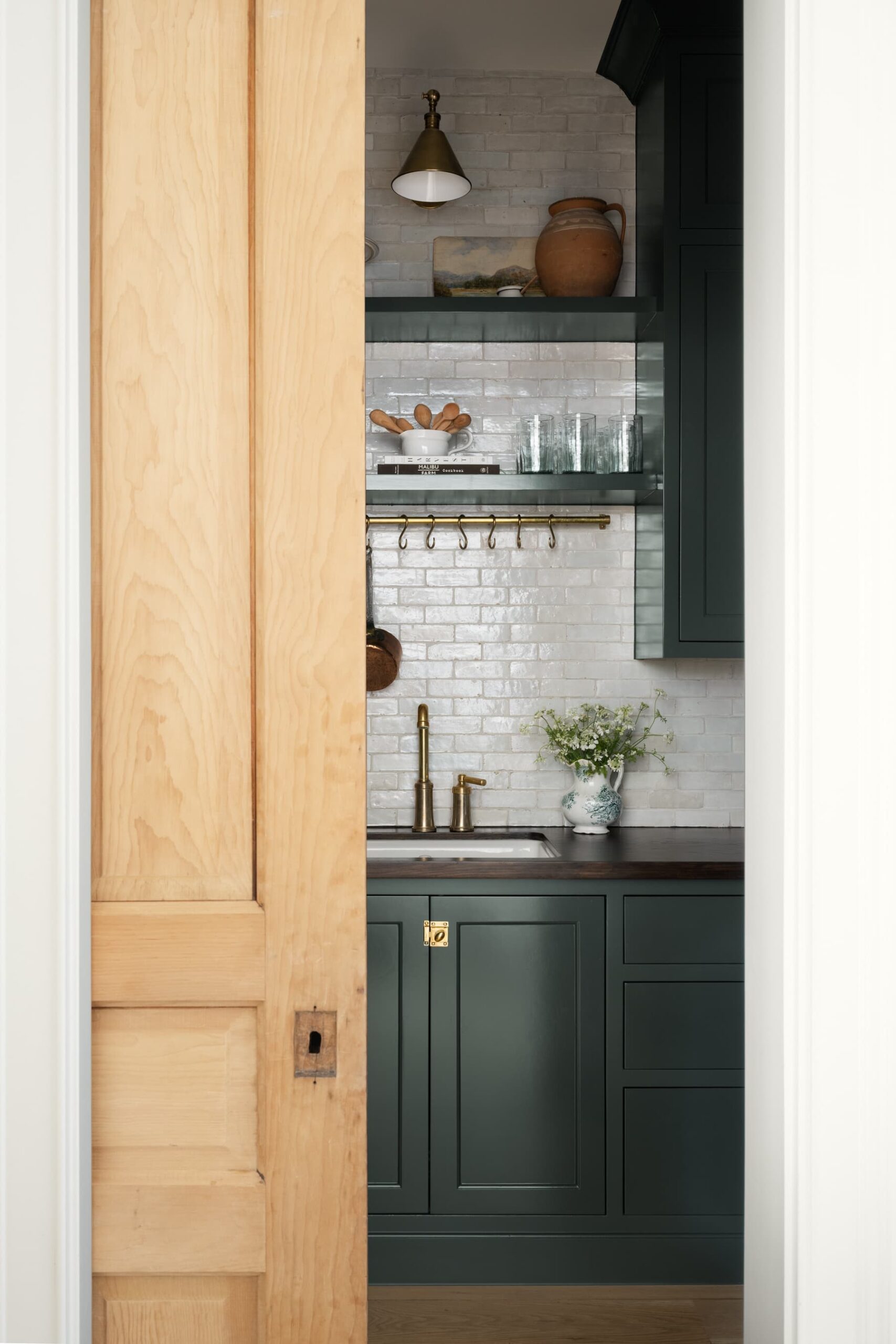 Not so long ago, white was the backdrop color used for creating a timeless, clean and fresh home. The new neutral isn't white.  It seems warmer, less crisp and more lived-in, now. Studio McGee Interiors | Lucy Call Photography - butler's pantry with tile backsplash and pot hanger