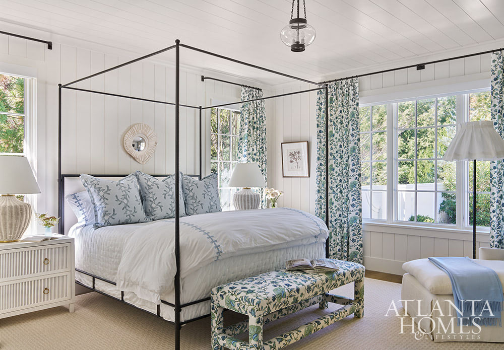 SOURCE; Atlanta Homes & Lifestyles INTERIOR DESIGN  Virginia Nocharli Design  ARCHITECT: Greg Busch Architects BUILDER Rhett Bonner, Bonner Buchanan  LANDSCAPE ARCHITECT  Richard Anderson Landscape Architect - black canopy bed with blue and white bedding in the primary bedroom with a white chaise