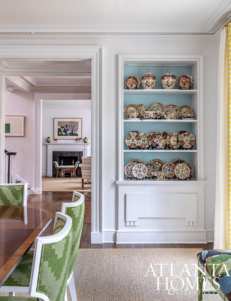 We don’t know about you, but we always love a good house tour.  To that end, Architect Norman Askins and Designer Chris Holt of Holt Interiors absolutely deliver. We are loving the sleek color palettes and sophisticated vibe of this stunning home–with pops of color in all the right places and the perfect dash of metallic chic. Blue wallpaper in back of china cabinet in dining room