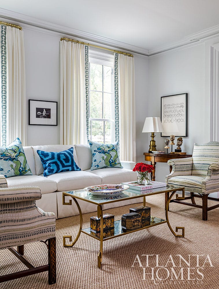 We don’t know about you, but we always love a good house tour.  To that end, Architect Norman Askins and Designer Chris Holt of Holt Interiors absolutely deliver. We are loving the sleek color palettes and sophisticated vibe of this stunning home–with pops of color in all the right places and the perfect dash of metallic chic.glass and brass coffee table in living room