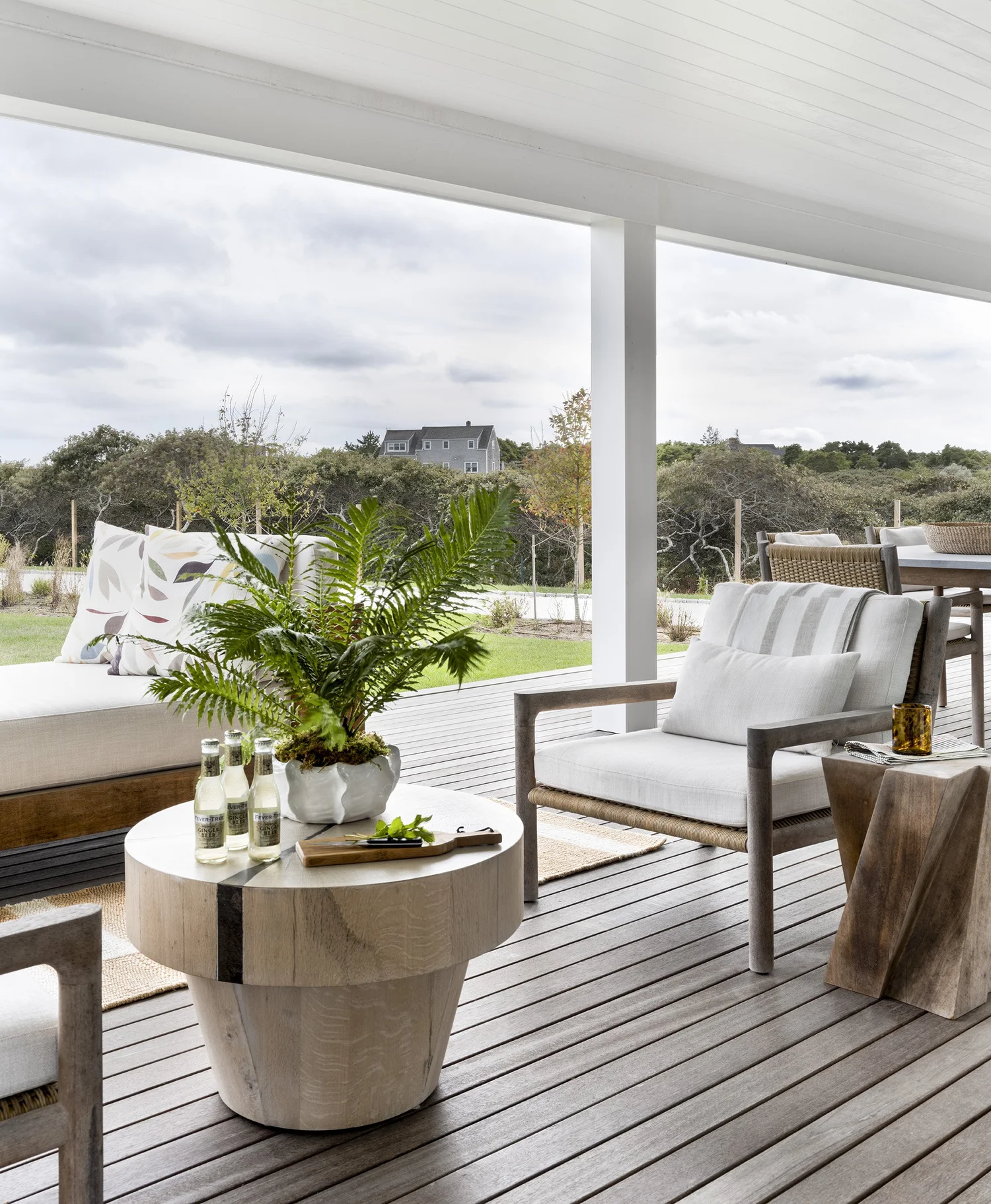 We hope you are having a great week–and are in the mood for touring a stunning home designed by the talented Honey Collins Interiors and beautifully photographed by Alison Gootee Photography.  Neutral enough to be calm, textured enough to be interesting, and layered into complete coziness, this is the perfect home for friends and family.  Whatever your design goals, you’ll find the inspiration to get your home makeover started on the right foot! covered porche with white furniture