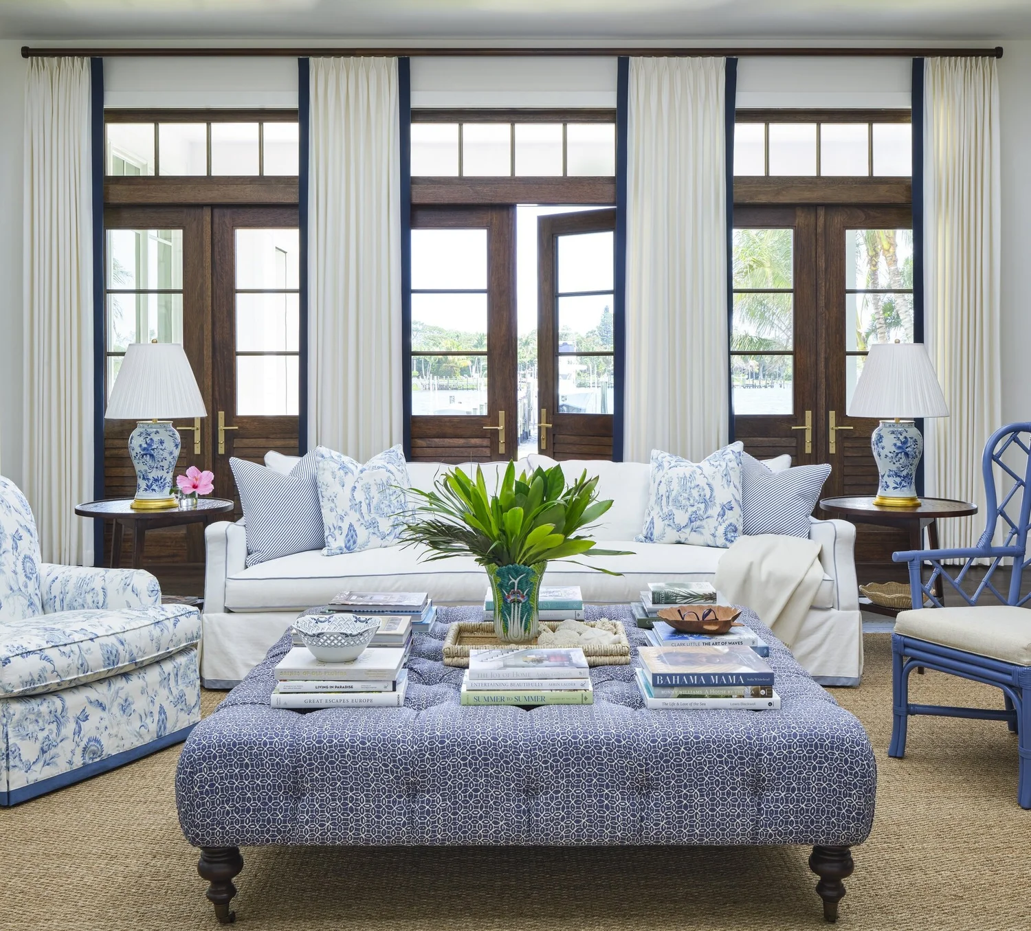 We hope you are having a great week–and are in the mood for touring a one-of-a-kind home designed by the talented Kara Miller and beautifully photographed by Brantley Photography. Neutral enough to be calm, textured enough to be interesting, and layered into complete coziness, this perfectly styled home is ideal for friends and family. Blue and white living room with French doors to the outdoors
