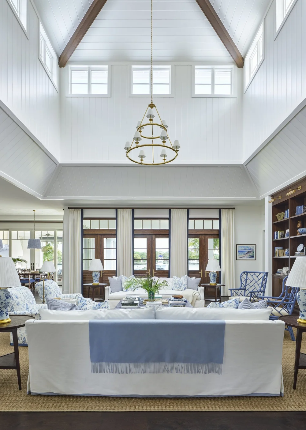 We hope you are having a great week–and are in the mood for touring a one-of-a-kind home designed by the talented Kara Miller and beautifully photographed by Brantley Photography. Neutral enough to be calm, textured enough to be interesting, and layered into complete coziness, this perfectly styled home is ideal for friends and family. Blue and white family room with soaring ceilings