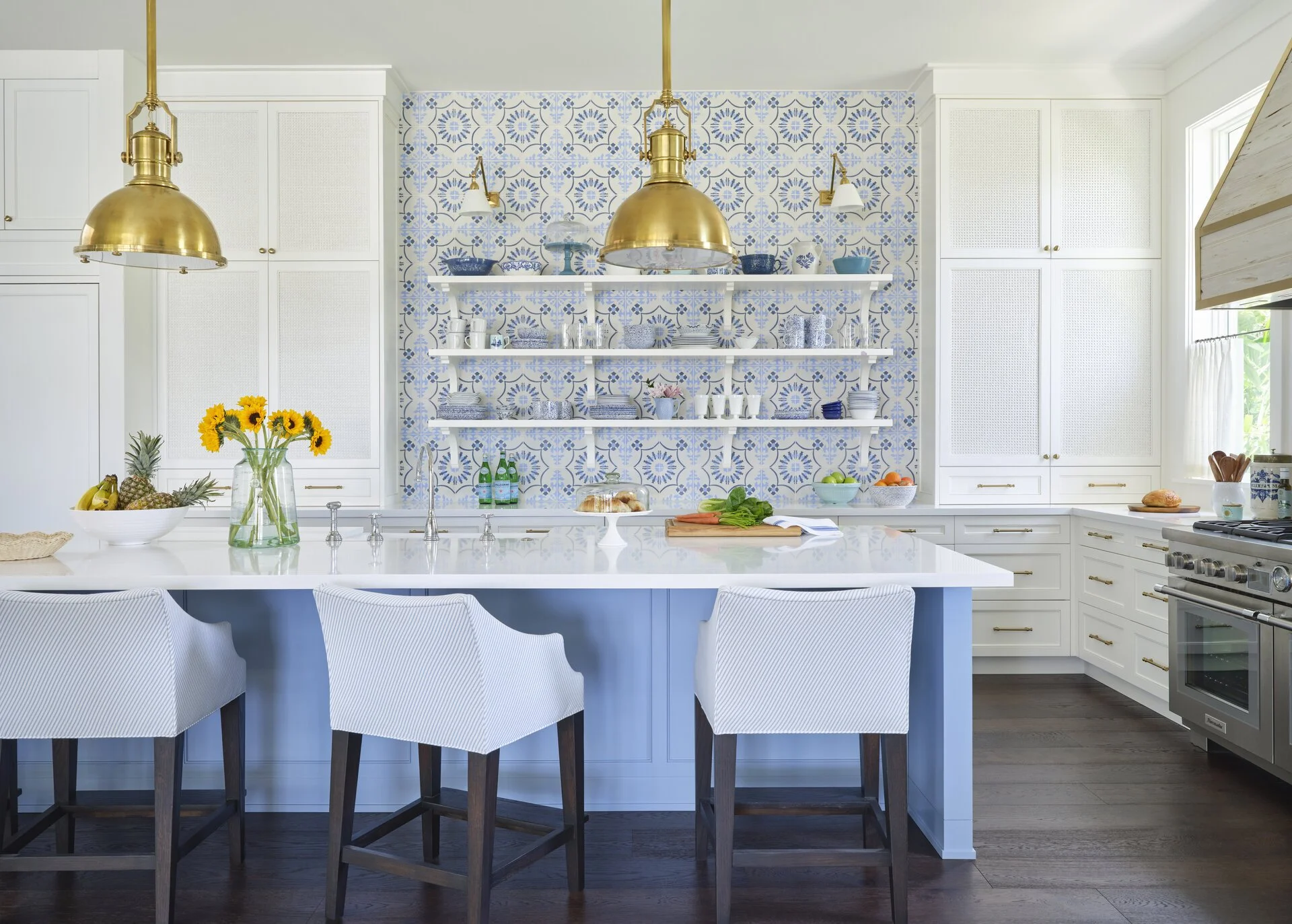 We hope you are having a great week–and are in the mood for touring a one-of-a-kind home designed by the talented Kara Miller and beautifully photographed by Brantley Photography. Neutral enough to be calm, textured enough to be interesting, and layered into complete coziness, this home is ideal for friends and family.Beautiful blue and white tile int this gorgeous kitchen with brass pendant lights and open shelving