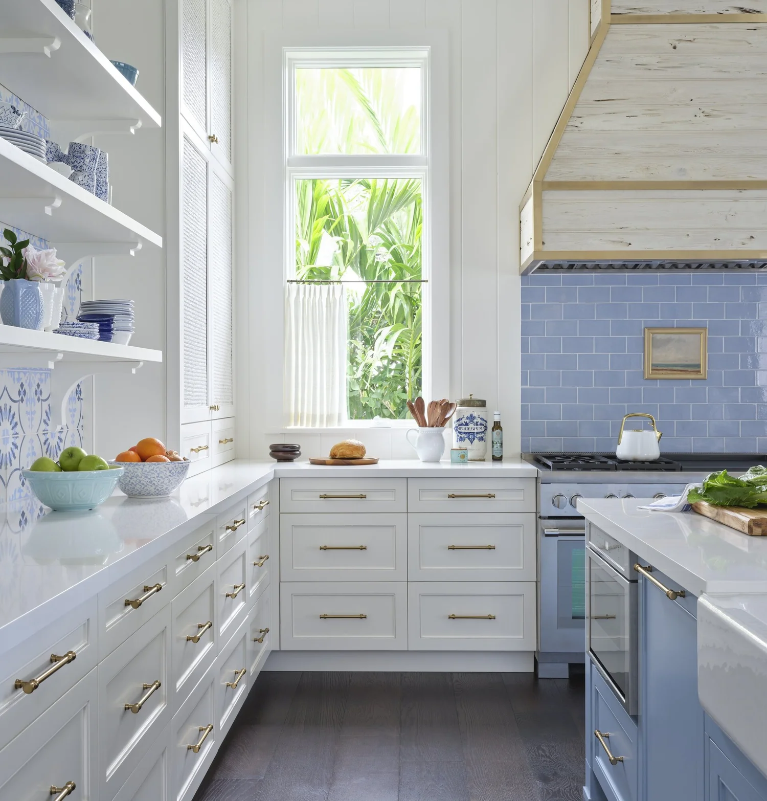 We hope you are having a great week–and are in the mood for touring a one-of-a-kind home designed by the talented Kara Miller and beautifully photographed by Brantley Photography. Neutral enough to be calm, textured enough to be interesting, and layered into complete coziness, this home is ideal for friends and family.Beautiful blue and white tile int this gorgeous kitchen with brass pendant lights and open shelving