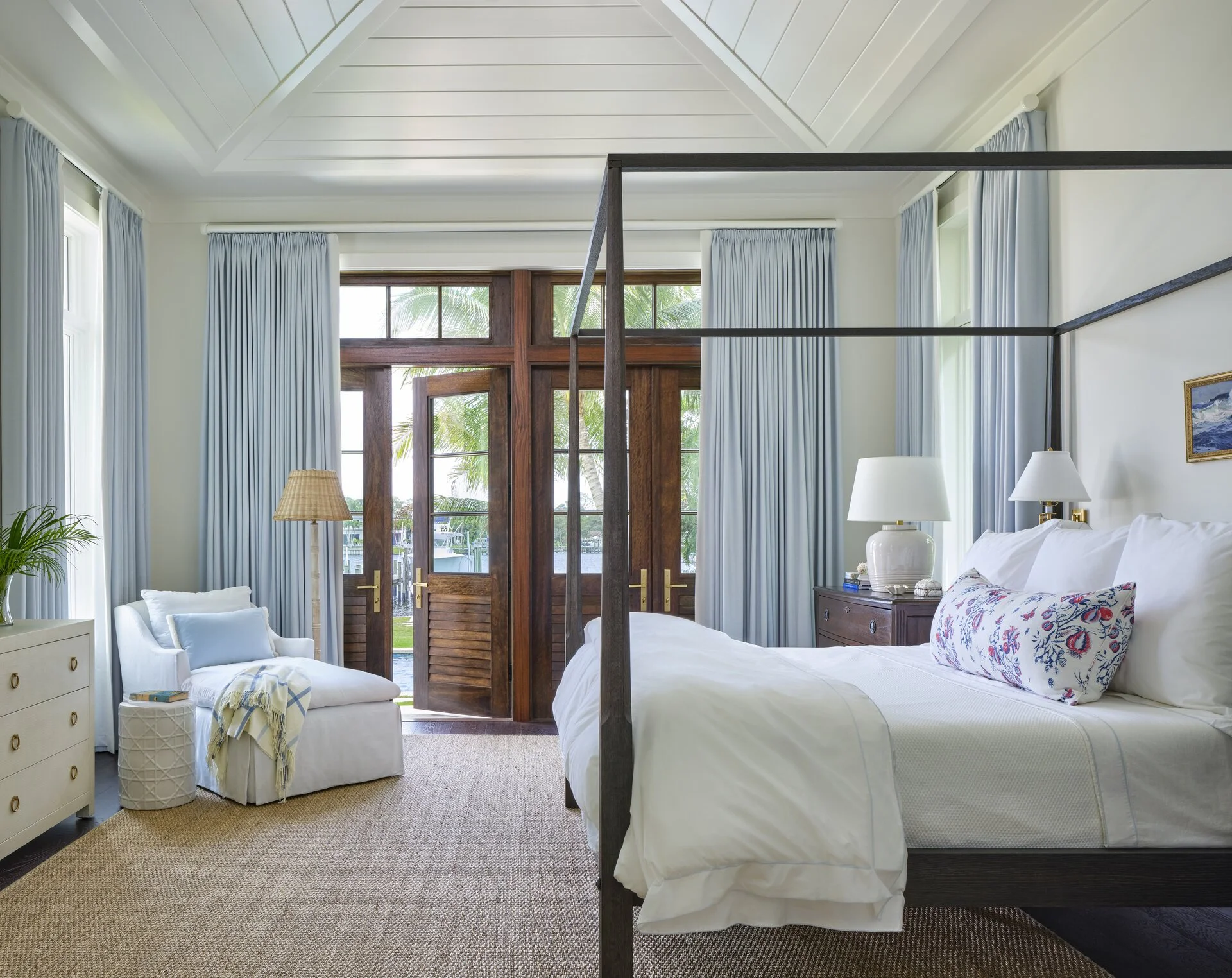 We hope you are having a great week–and are in the mood for touring a one-of-a-kind home designed by the talented Kara Miller and beautifully photographed by Brantley Photography. Neutral enough to be calm, textured enough to be interesting, and layered into complete coziness, this home is ideal for friends and family.Beautiful blue and white bedroom with canopy bed and white chaise