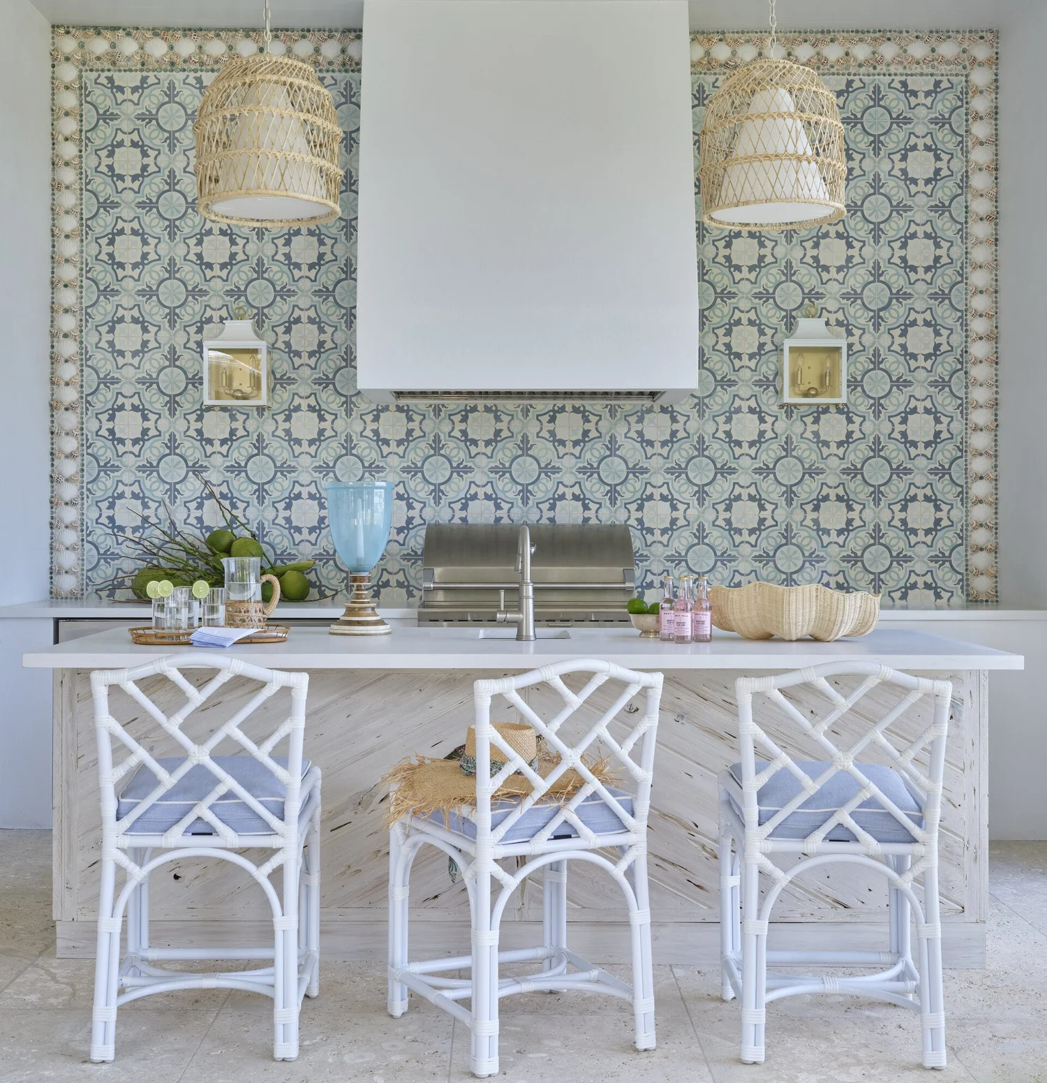 We hope you are having a great week–and are in the mood for touring a one-of-a-kind home designed by the talented Kara Miller and beautifully photographed by Brantley Photography. Neutral enough to be calm, textured enough to be interesting, and layered into complete coziness, this home is ideal for friends and family.Beautiful blue and white tile in this outdoor kitchen with white chippendale stools and wicker pendants