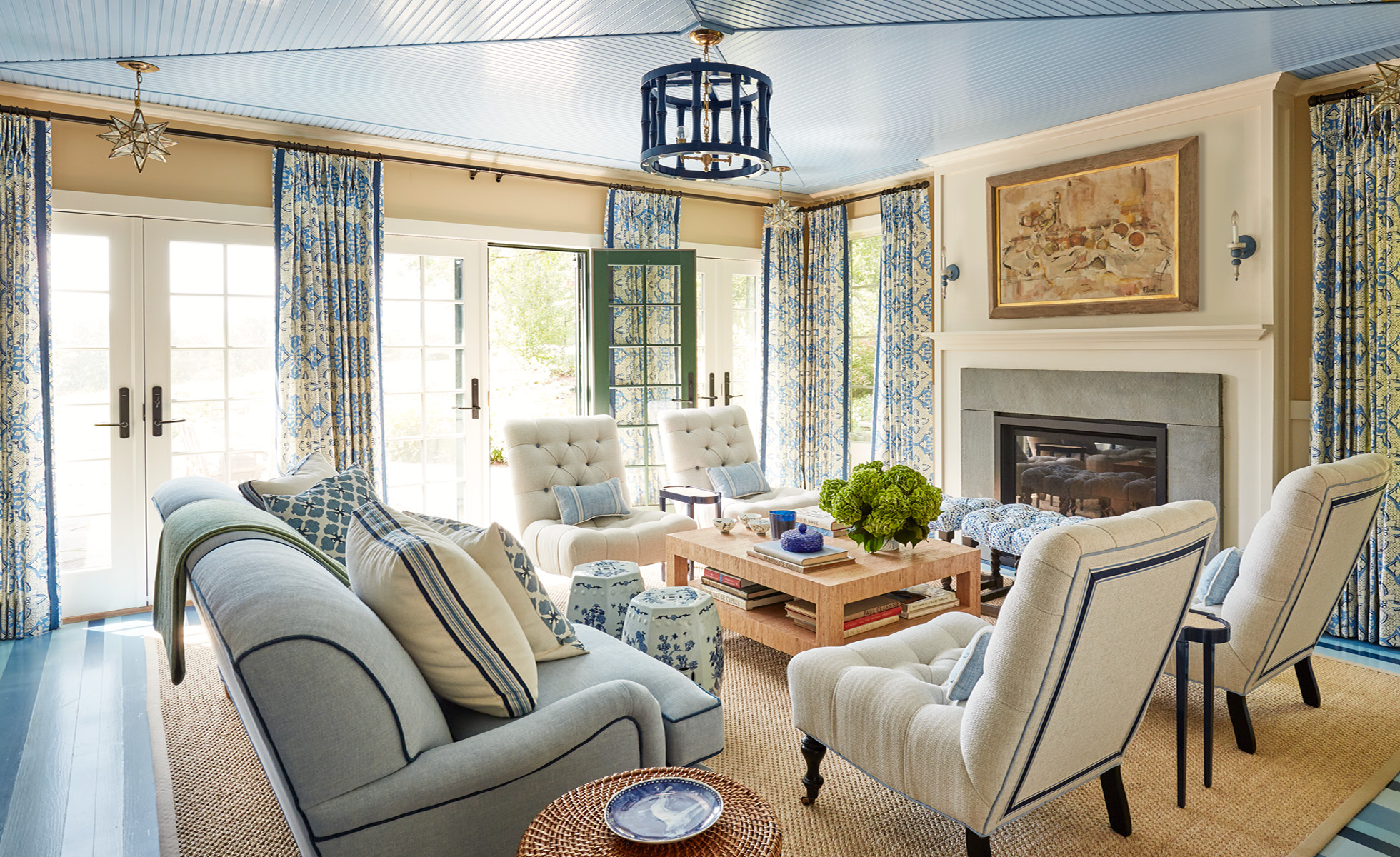 If so, you’re in for a treat today. Todays historic Catskill cottage tour designed by the talented team at Amanda Reynal Interiors is a refuge from the fast pace of modern life.   Charming and livable with lush surroundings and even lusher interiors, this home will make you feel a world away without ever leaving your living room. Thomas Loof Photography - blue and white living room