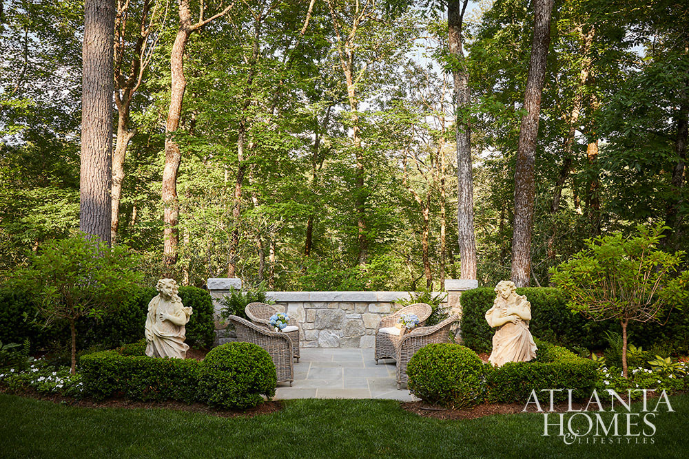 Well-defined beds, charming gravel paths, parterre gardens, and evergreen plantings form the backdrop for a garden that will flourish well into the future.