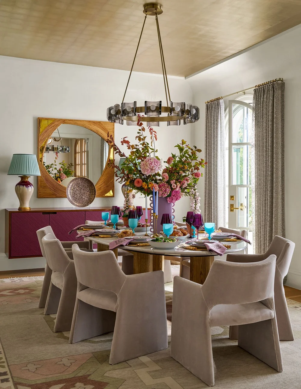 In a world full of minimalism and clean lines, traditional design is making a quiet comeback. It’s the perfect mix of classic touches and updated details, well-suited for family living and entertaining. Where stunning moldings and architectural details live comfortably with more casual room. Mary Beth Wagner Interior Design - Nathan Schroder Photography - Dining room with oval glass table and gilded ceiling
