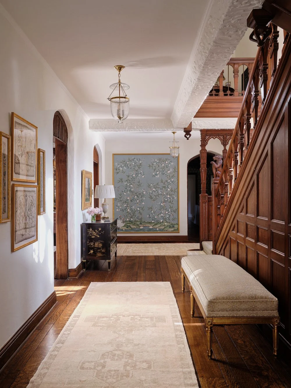 You'll love how Jenkins Interiors beautifully blends old and new in this timeless home, preserving history while updating it for modern life. Love ths arched doorways in this foyer with bell jar lantern and stained staircase - Stephen Karlish Photography