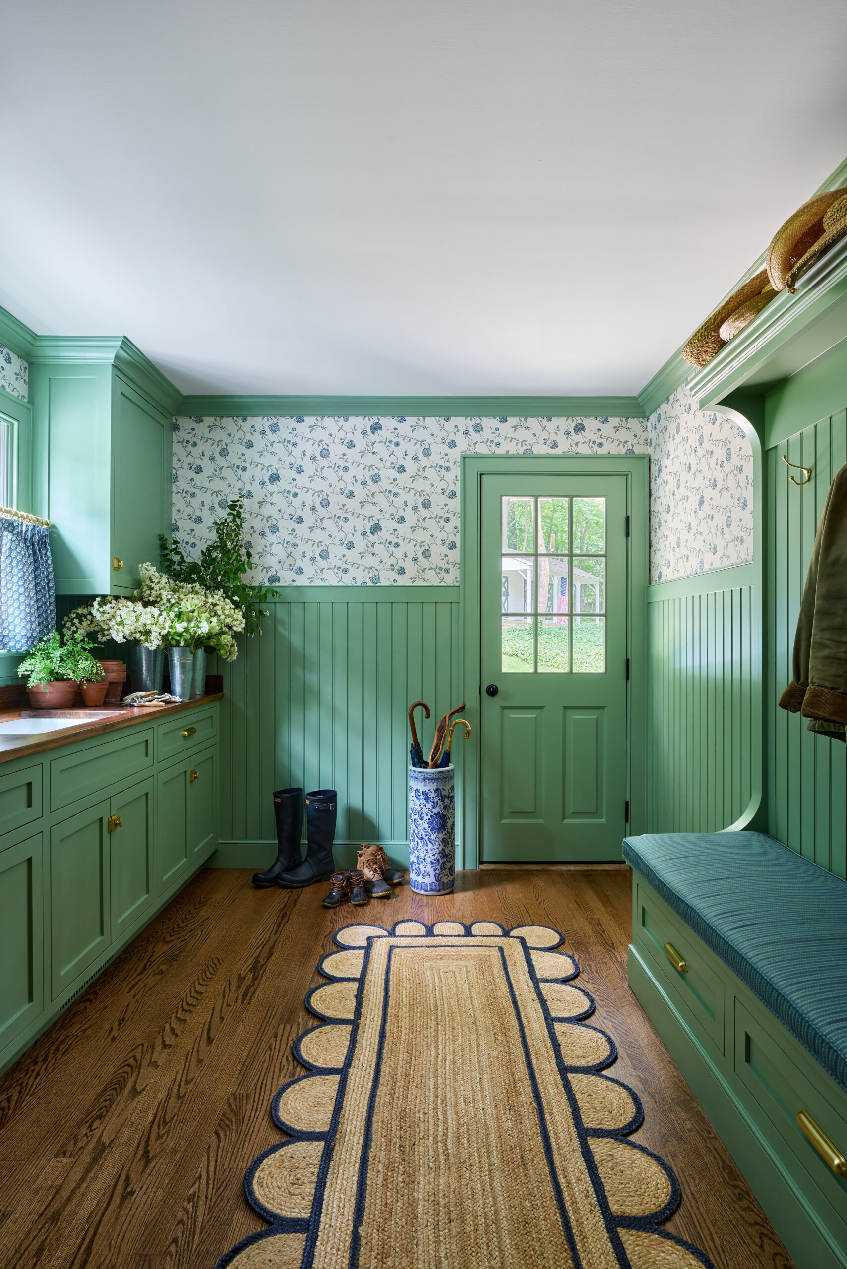 Kirsten Francis Photography | Matthew Gleason Stylist - beautiful green mudroom with scalloped seagrass rug