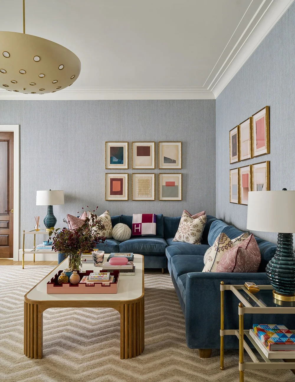 In a world full of minimalism and clean lines, traditional design is making a quiet comeback. It’s the perfect mix of classic touches and updated details, well-suited for family living and entertaining. Where stunning moldings and architectural details live comfortably with more casual room. Mary Beth Wagner Interior Design - Nathan Schroder Photography - Beautiful blue velvet sectional sofa in living room 