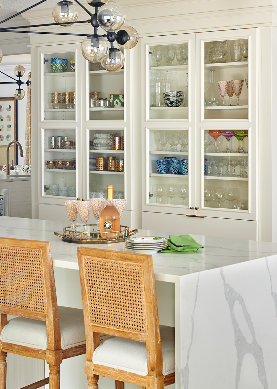 Step inside this warm and inviting home designed by Amanda Reynal, and then take another peek so you don't miss a single detail! - Adam Albright PHotography - love the glass cabinets in the kitchen 