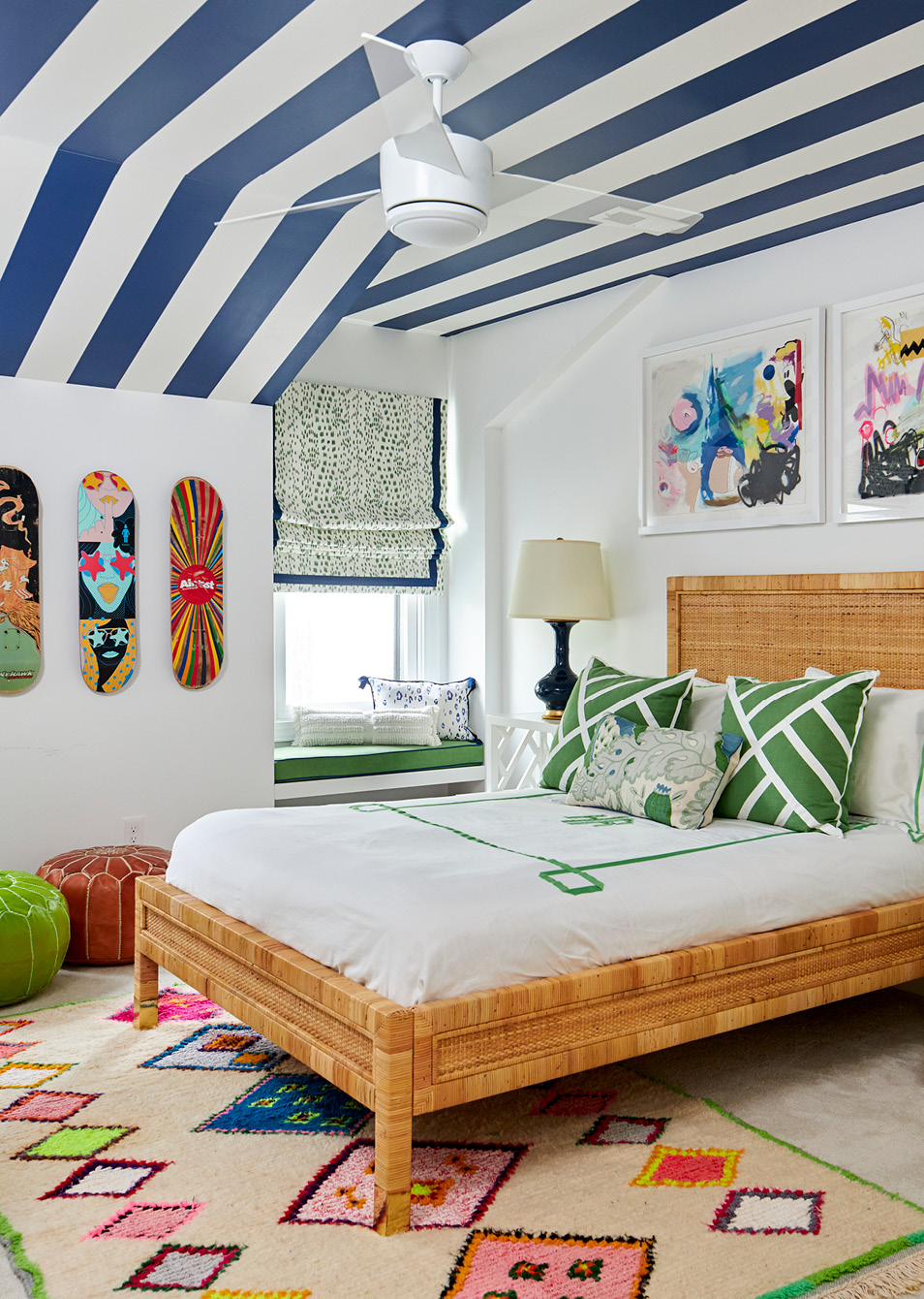 Warm, inviting, and completely livable, we adore this Amanda Reynal designed home, beautifully photographed by Adam Albright! Step inside and then take another peek so you don't miss a single detail! love the blue and white stripe wallpaper on the ceiling in this teenager's bedroom with the skateboard art on the walls