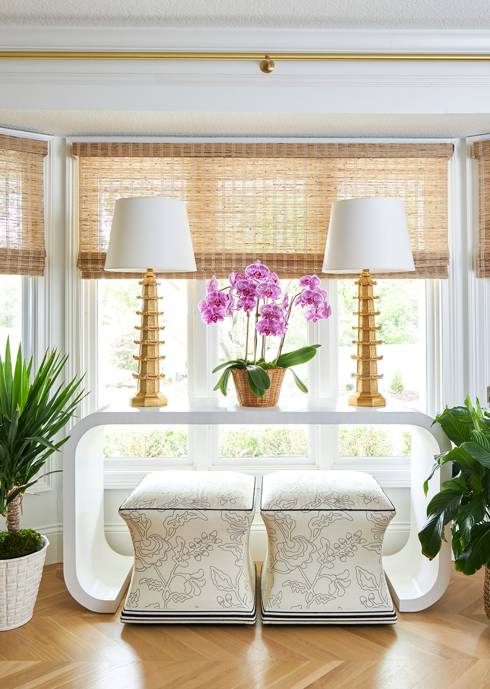 Step inside this warm and inviting home designed by Amanda Reynal, and then take another peek so you don't miss a single detail! - Adam Albright PHotography - love the pair of lamps on the console table with stools underneath the console table