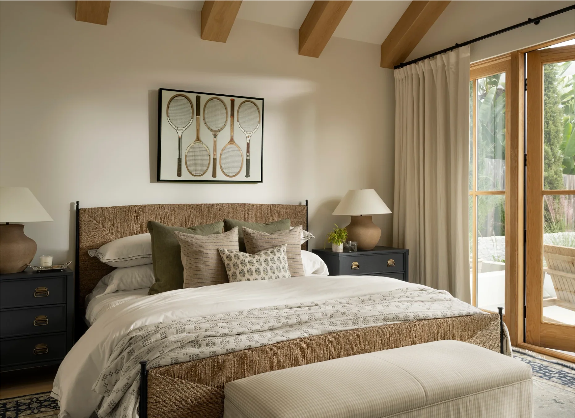 Refined yet laid-back, elegant yet welcoming, these bedrooms designed by Studio McGee ,  feel like home.  Lucy Call Photography - tennis racket art in neutral bedroom with wood beams