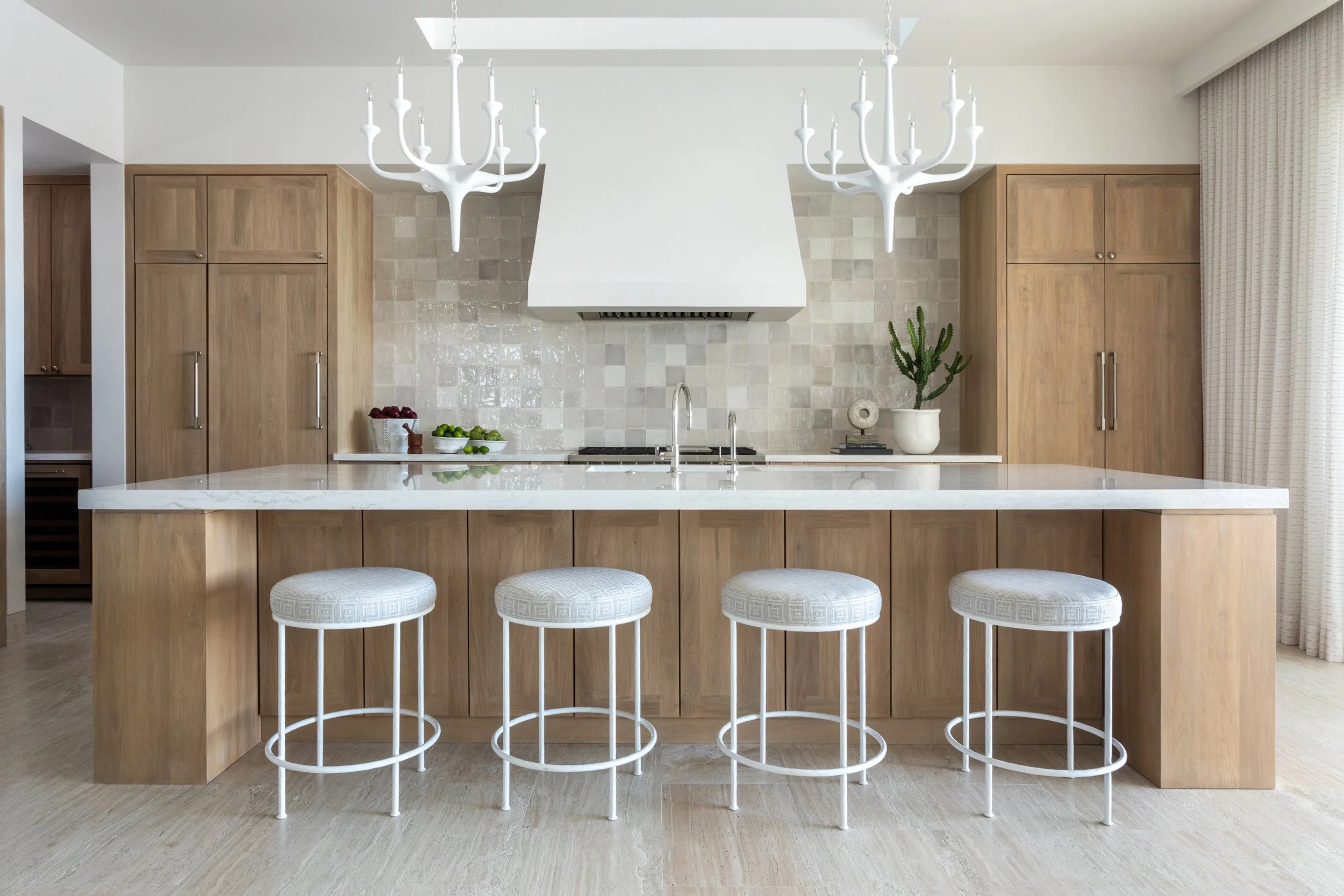 That’s the enchanting essence permeating every corner of this stunning Cabo vacation home designed by A. Wooten Interiors.   Photography: Heidi Harris - kitchen with blonde wood