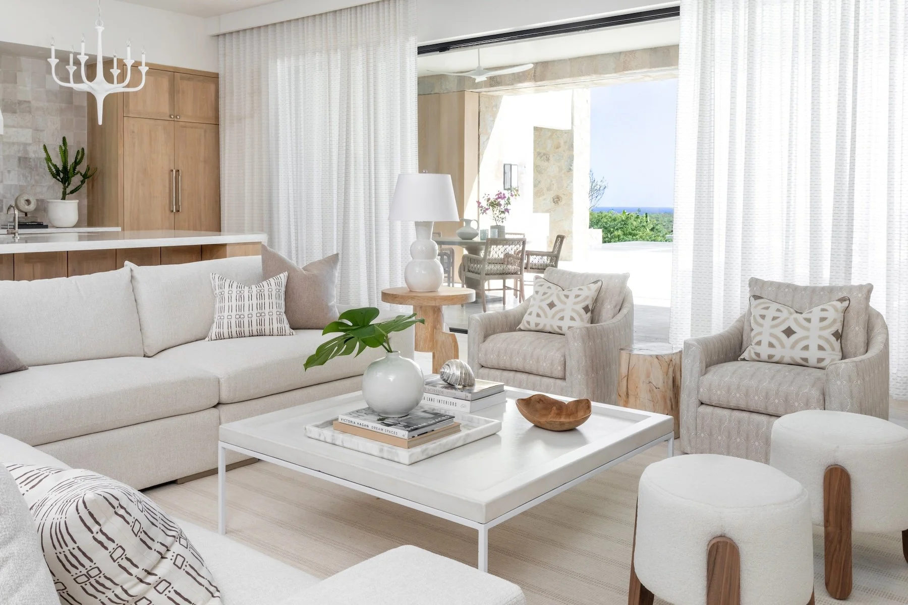 That’s the enchanting essence permeating every corner of this stunning Cabo vacation home designed by A. Wooten Interiors.   Photography: Heidi Harris - neutral living room with open concept living