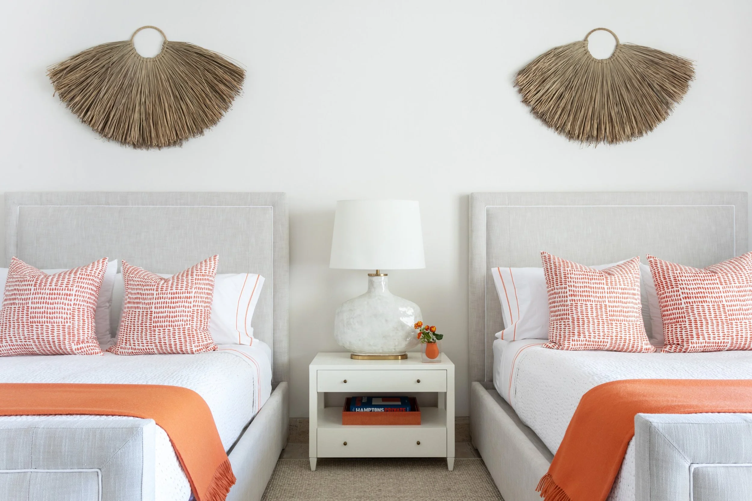 A. Wooten Interiors.   Photography: Heidi Harris love the orange and white bedding in this guestroom