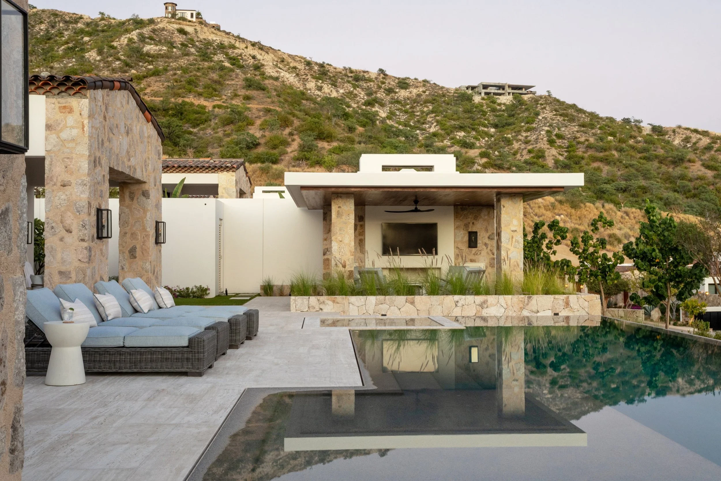 That’s the enchanting essence permeating every corner of this stunning Cabo vacation home designed by A. Wooten Interiors.   Photography: Heidi Harris - beautiful stone used for this gorgeous home and pool area