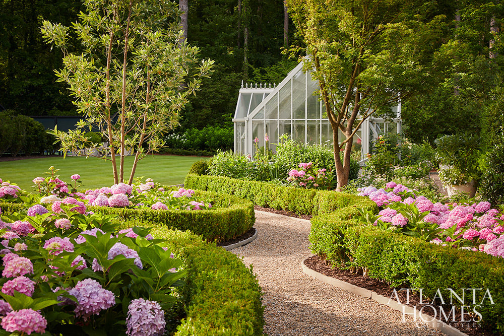 Source Atlanta Homes & Lifestyles | Interior Design by Andrea Henzlik Design  | Architect Greg Busch Architects | Photographed by Emily Followill | Styled by Eleanor Roper  | Landscape Architect Carson McElheney, Hamilton Land Services Inc | Builder Roger Balko - beautiful garden with pea gravel pathways and charming greenhouse