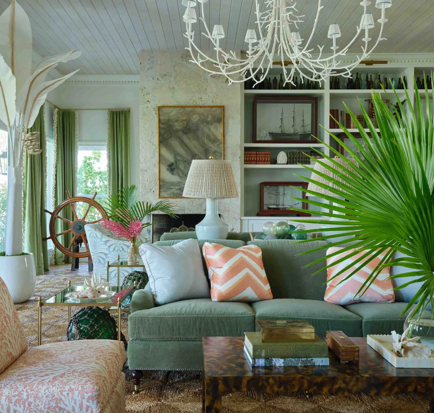 Tour a traditional coastal home with beautiful antiques, collected charm, and a relaxed seaside feel. You'll love every fabulous detail! Beauitufl deGourney wallpaper in foyer with palm trees and antique console table and terra cotta tiles