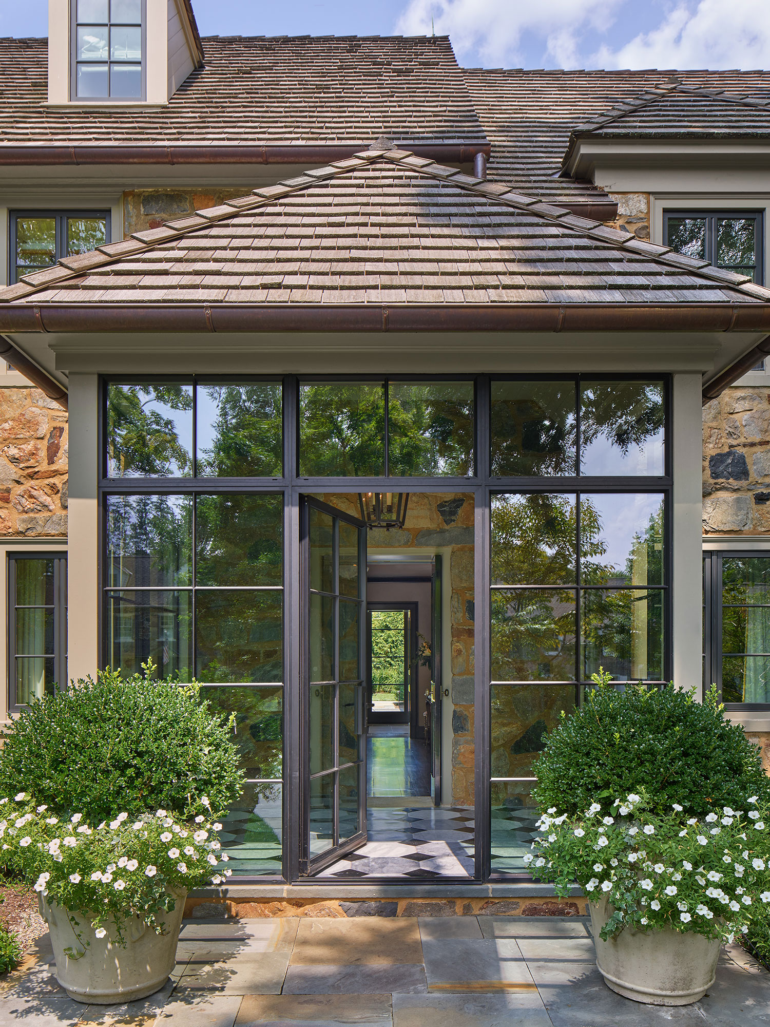 Archer & Buchanan Architects | Halkin | Mason Photography -Steel doors on the back entry of this beautiful traditional home