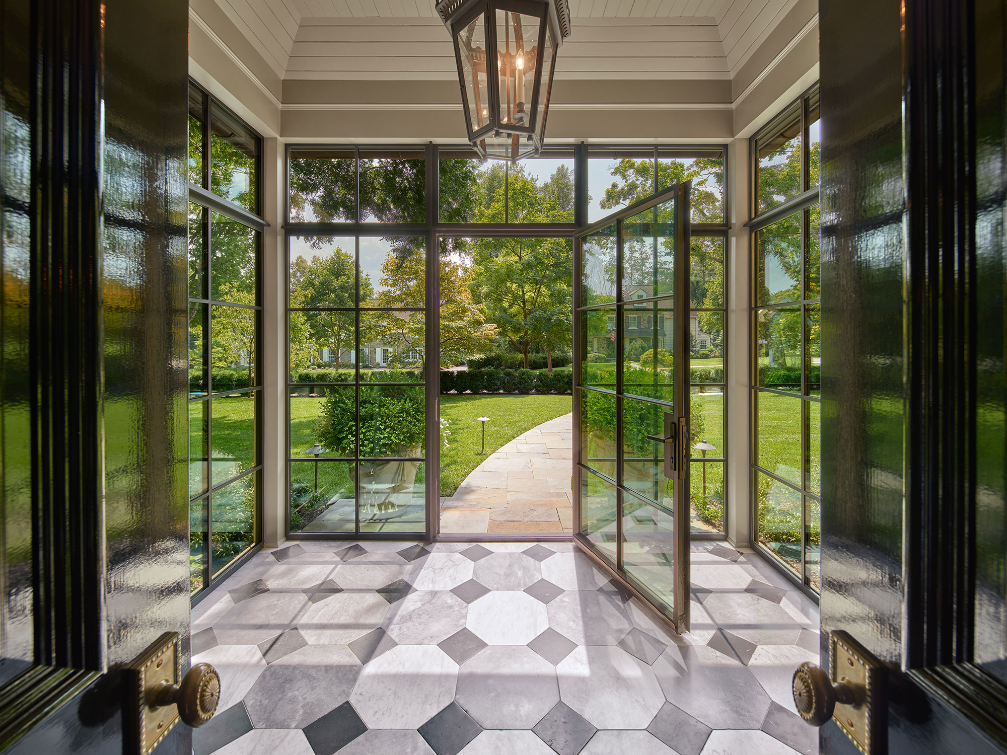 Archer & Buchanan Architects | Halkin | Mason Photography -love the marble floors in the back entry of this traditional home with steel doors