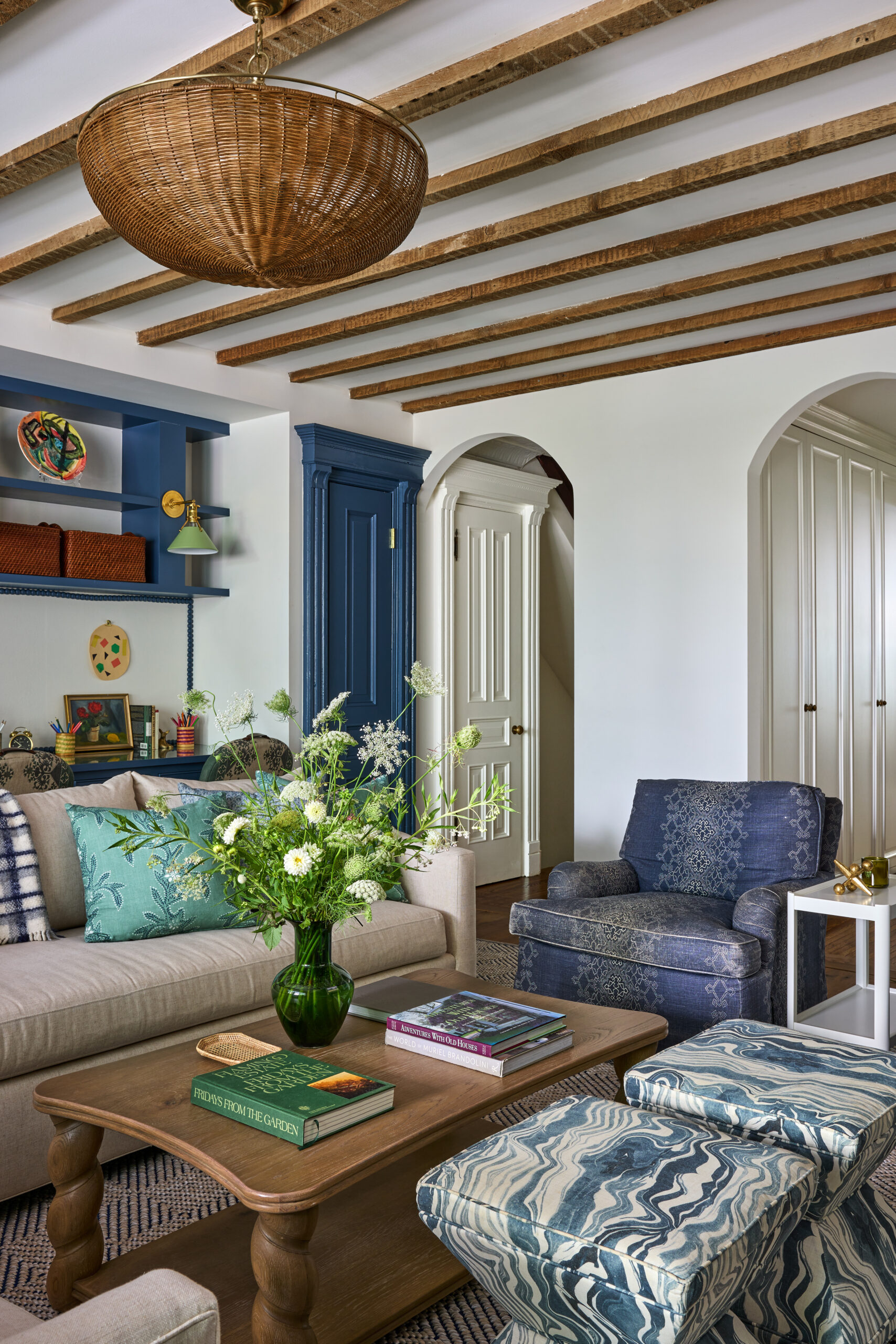 Jennifer Hunter Design | Kristen Francis Photography | Frances Bailey Styling - love the wood beams, arched doorways and Visual Comfort wicker chandelier in the living room