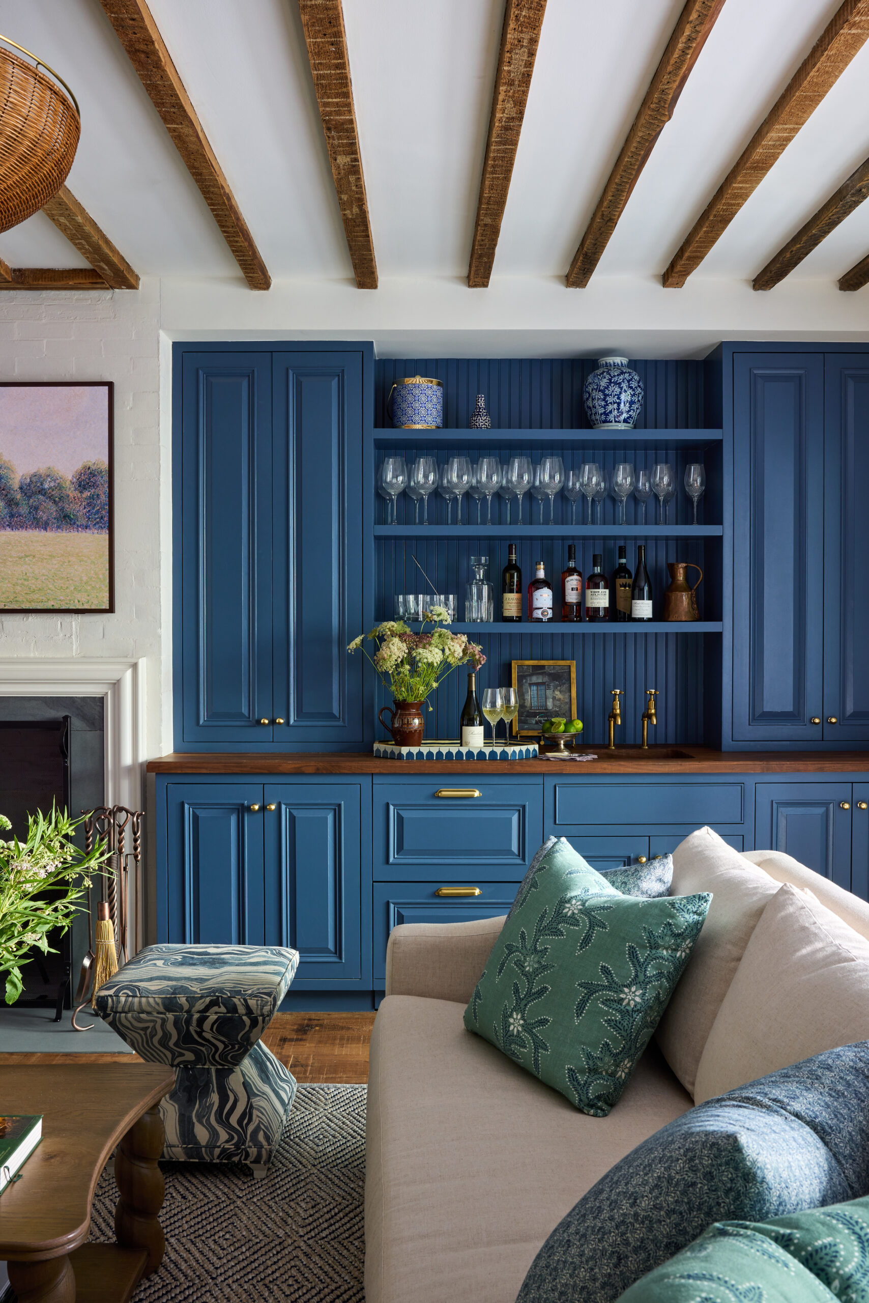 Jennifer Hunter Design | Kristen Francis Photography | Frances Bailey Styling - love the wood beams and Visual Comfort wicker chandelier in the living room with the beautiful bar