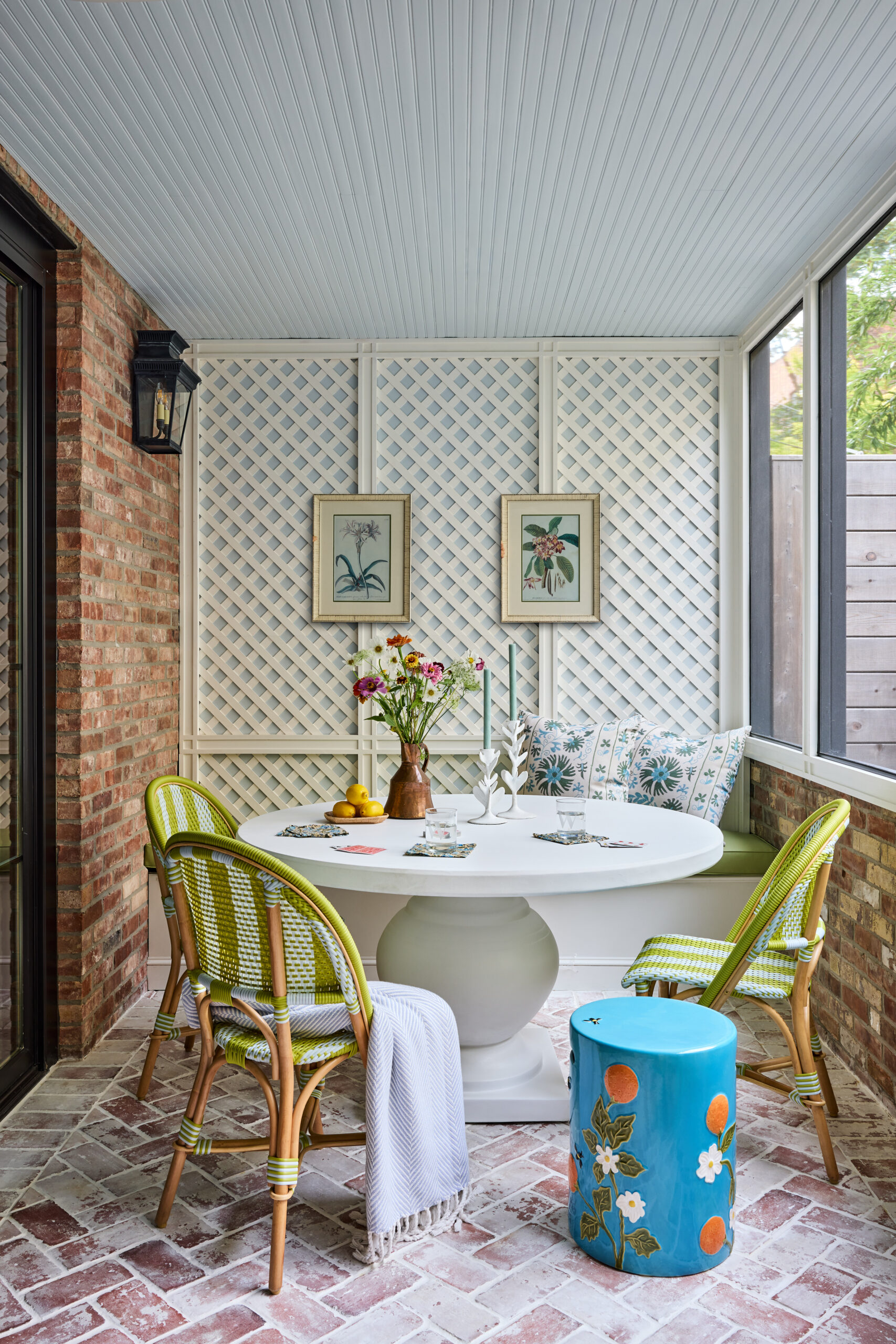 Jennifer Hunter Design | Kristen Francis Photography | Frances Bailey Styling - Charming covered porche with a round table and green riviera chairs perfect for dining or game night