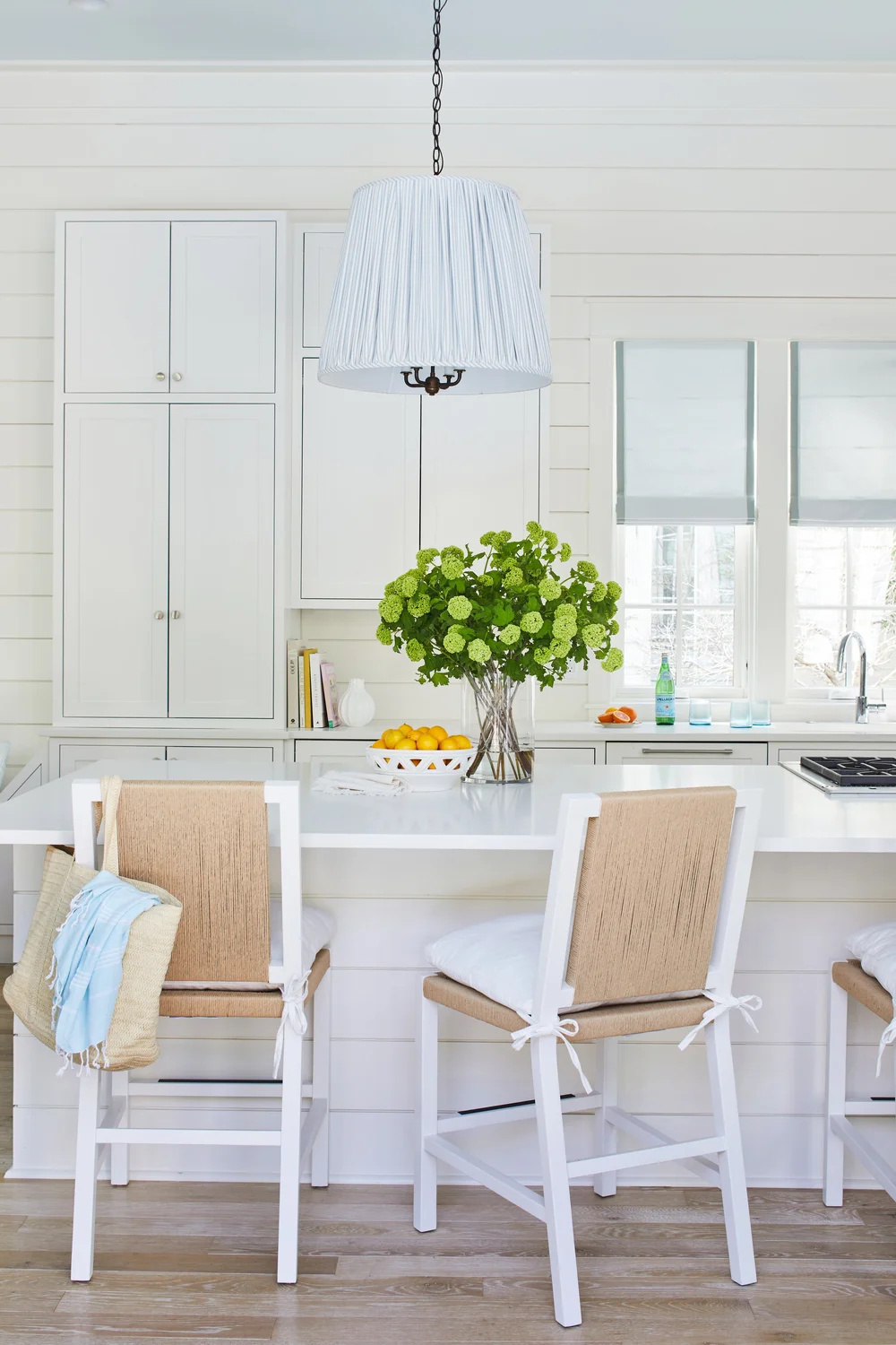 Utterly charming Kara Miller-designed beach house, photographed by Laurey W. Glenn and styled by Lindsey Ellis Beatty, feels fresh and inviting. The various color tones, natural materials, and textured accents ground each space, creating a livable home with plenty of style. white kitchen with shiplap