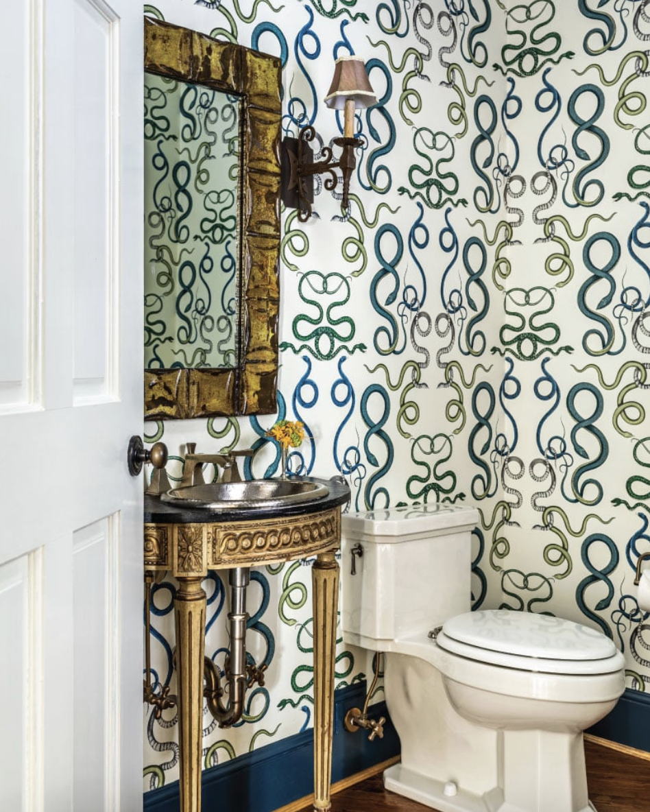 Designed byAlexa Stevenson Interiors, with photography by Jeff Herr, is the perfect mix of traditional touches and updated details, well-suited for family, entertaining and more. powder room with snake wallpaper