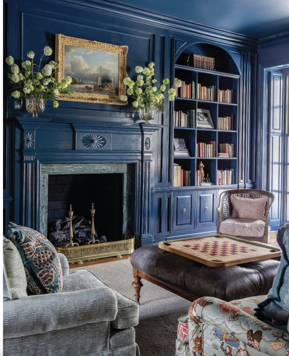  This stunning traditional home, designed byAlexa Stevenson Interiors, with photography by Jeff Herr, is the perfect mix of traditional touches and updated details, well-suited for family, entertaining and more. Color drenched familly room in moody blue - with beautiful bookcases