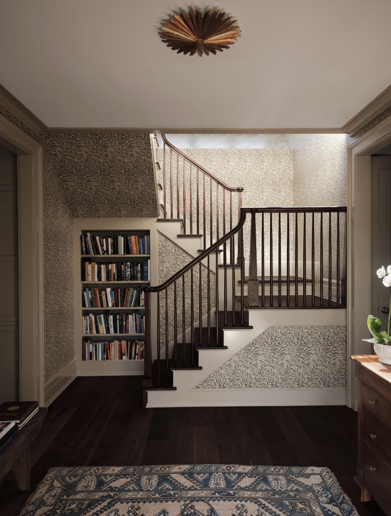 Check out this gorgeous home designed by one of our favorites, Sabbe Interior Design. with beautiful photography by Joseph Bradshaw.  - Love the charming wallpaper and bookcase in this entry foyer with the Visual Comfort lighting