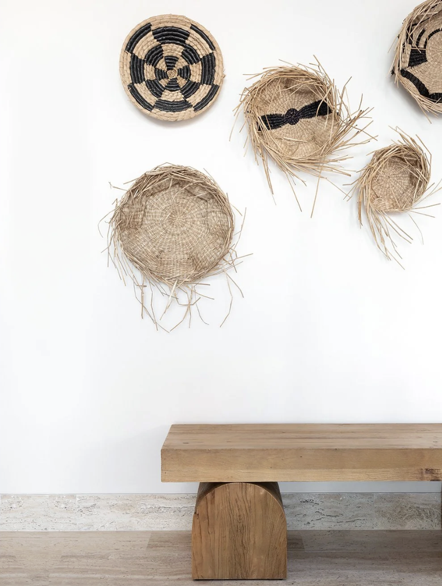 That’s the enchanting essence permeating every corner of this stunning Cabo vacation home designed by A. Wooten Interiors.   Photography: Heidi Harris - love the collection of hanging baskets on the wall
