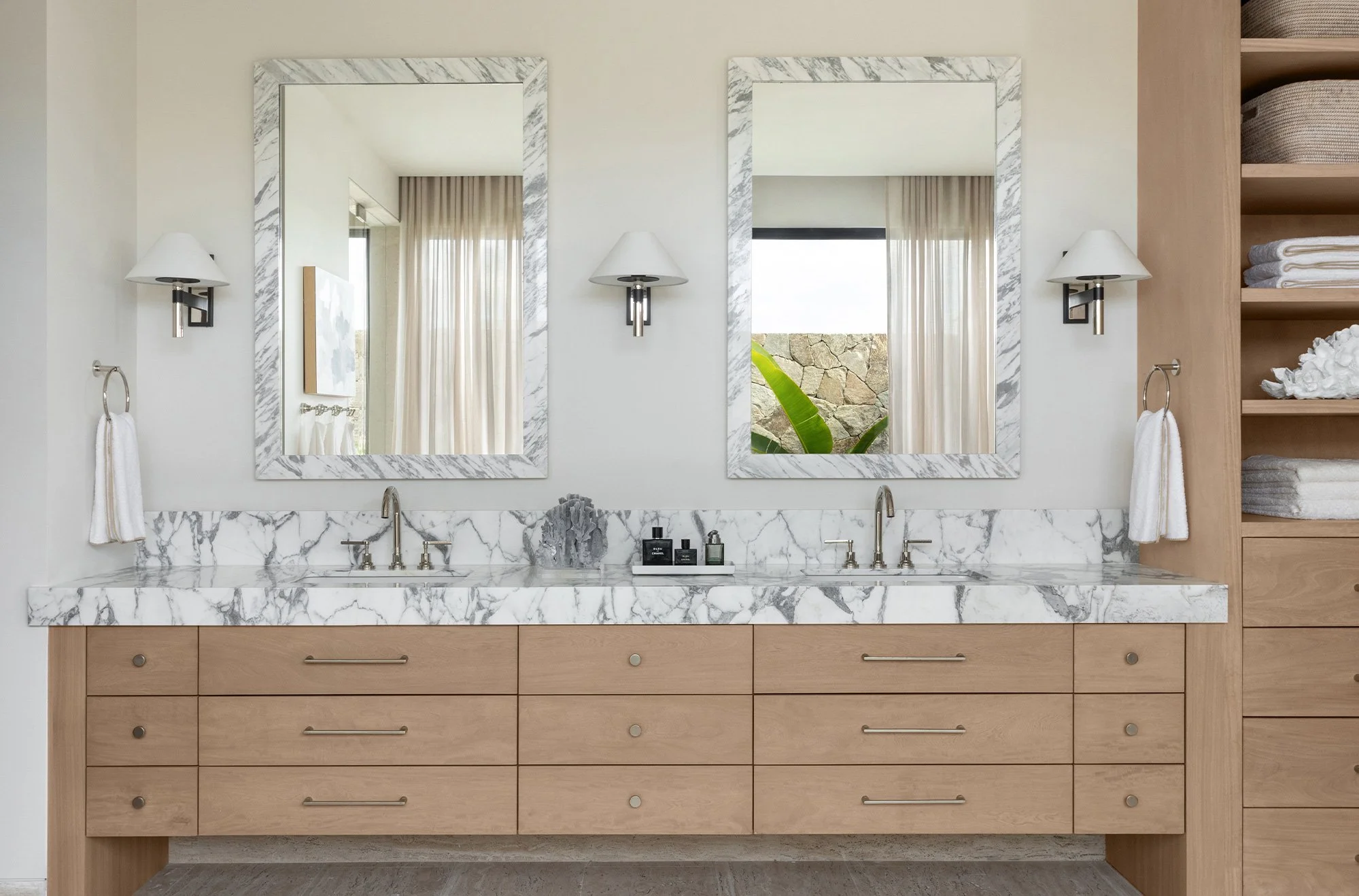 That’s the enchanting essence permeating every corner of this stunning Cabo vacation home designed by A. Wooten Interiors.   Photography: Heidi Harris love the bathroom with blonde wood and marble countertops