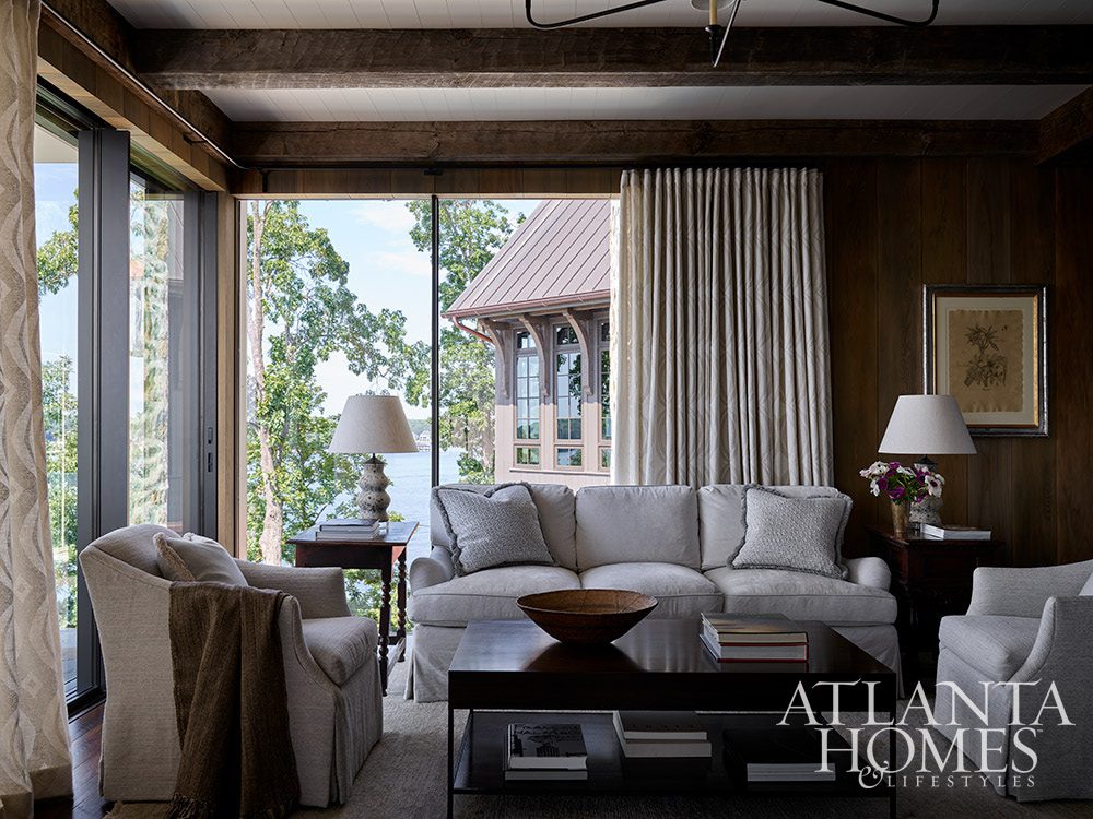 Source: Atlanta Homes & Lifestyles Interior Designer: Jackye Lanham, Jacquelynne P. Lanham Designs Architect: John D. Haley, John D. Haley Builder: Scott McMillan, Kingswood Custom Homes, Inc. Landscape Architect: John Howard, Howard Design Studio - love the dark stained wood with floor to ceiling windows in this fabulous lake house