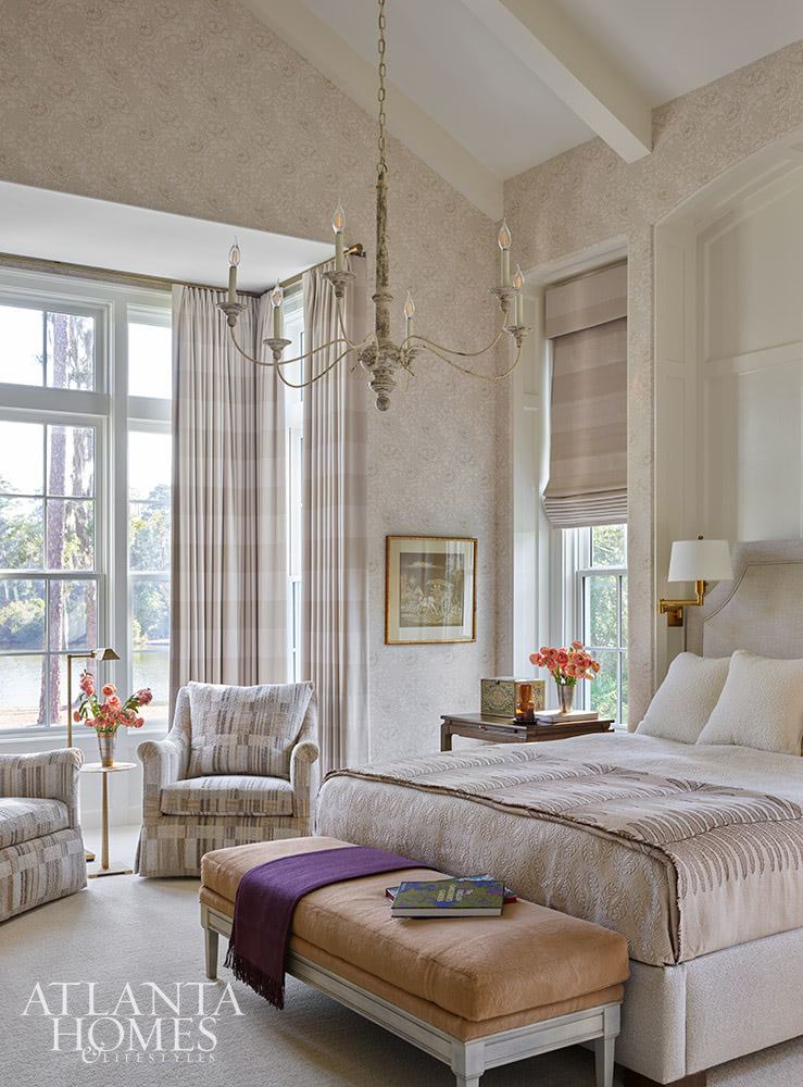 INTERIOR DESIGN: Kim Scodro Interiors| ARCHITECT: William Court, Court Atkins Group | BUILDER: Brett Flanagan, Flanagan Development | LANDSCAPE ARCHITECT: Troy Anderson, Spartina Studio | CABINETRY DESIGN: Jamestown Designer Kitchens | PHOTOGRAPHY: Emily Followill Photography | STYLIST: Eleanor RoperBeautiful neutral primary bedroom with chandelier and sitting area in windows
