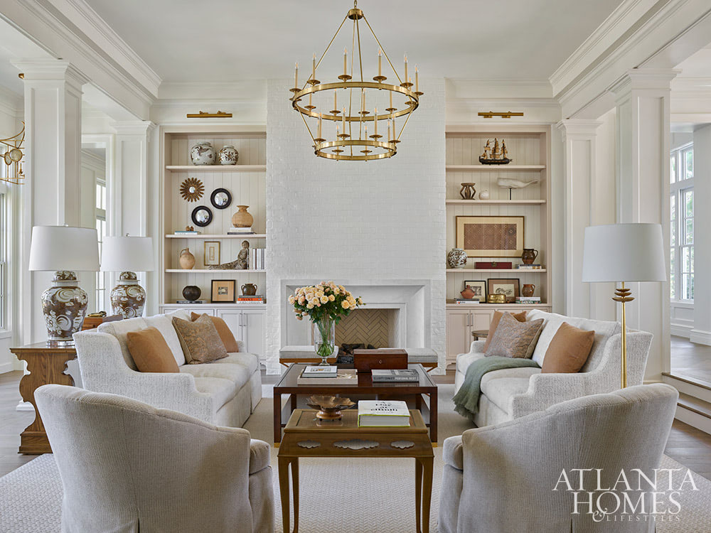 With the days getting longer and the warmer, it's the perfect time to take a trip to a gorgeous St. Simons Island home . Lush surroundings and even lusher interiors make this the ideal getaway. Neutral living room with brass chandelier
