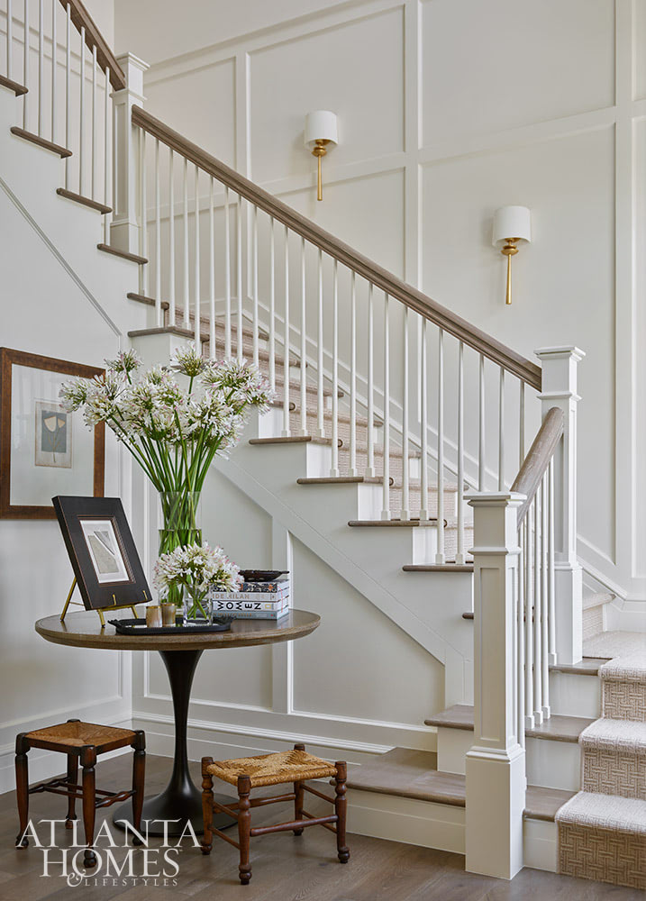 INTERIOR DESIGN: Kim Scodro Interiors| ARCHITECT: William Court, Court Atkins Group | BUILDER: Brett Flanagan, Flanagan Development | LANDSCAPE ARCHITECT: Troy Anderson, Spartina Studio | CABINETRY DESIGN: Jamestown Designer Kitchens | PHOTOGRAPHY: Emily Followill Photography | STYLIST: Eleanor Roper With the days getting longer and the warmer, it's the perfect time to take a trip to a gorgeous St. Simons Island home . Lush surroundings and even lusher interiors make this the ideal getaway. Beautiful entryway with paneled walls and round entry table