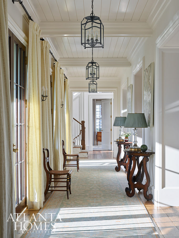 You’re going to love today’s post on the one-of-a-kind home designed by Nancy Izlar.  Known for her livable yet elegant aesthetic, Izlar seamlessly marries the best of both family heirlooms and traditional design elements for a collected style. Every corner of this perfectly styled home in Buckhead has been thoughtfully designed to maximize the breathtaking natural surroundings. With the large windows that let in plenty of natural light, this home combines beauty and comfort. Take a look at this timeless house tour, and we think you'll agree! Source: Atlanta Homes & Lifestyles | Interior Design: Nancy Izlar Interiors | Architect: Caroline Rolader, REU Architects | Builder: Wright Marshall and Greg DeLoach, Revival Construction | Landscape Architect: Land Plus | Photographed by Emily Followill | Styled by Holly Bryan and Erin Haraway - beautiful entryway with antique tables
