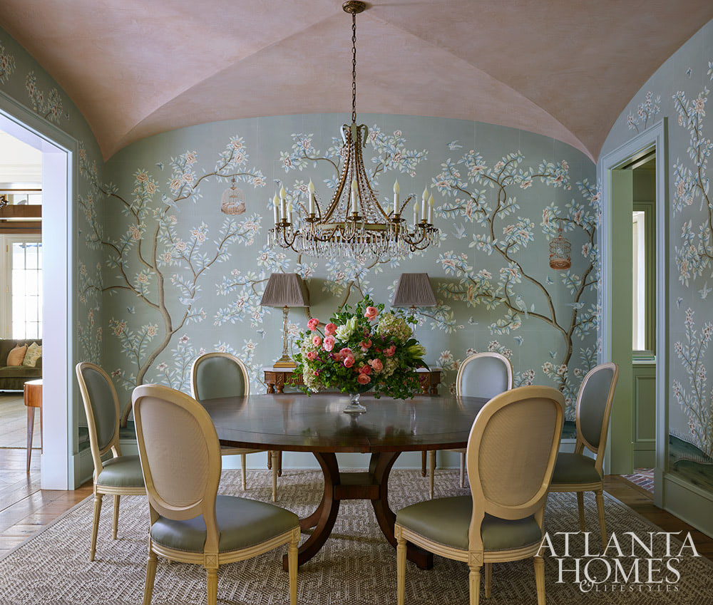 You’re going to love today’s post on the one-of-a-kind home designed by Nancy Izlar.  Known for her livable yet elegant aesthetic, Izlar seamlessly marries the best of both family heirlooms and traditional design elements for a collected style. Every corner of this perfectly styled home in Buckhead has been thoughtfully designed to maximize the breathtaking natural surroundings. With the large windows that let in plenty of natural light, this home combines beauty and comfort. Take a look at this timeless home tour, and we think you'll agree! - Source: Atlanta Homes & Lifestyles | Interior Design: Nancy Izlar Interiors | Architect: Caroline Rolader, REU Architects | Builder: Wright Marshall and Greg DeLoach, Revival Construction | Landscape Architect: Land Plus | Photographed by Emily Followill | Styled by Holly Bryan and Erin Haraway - beautiful dining room with round table and amazing wallpaper