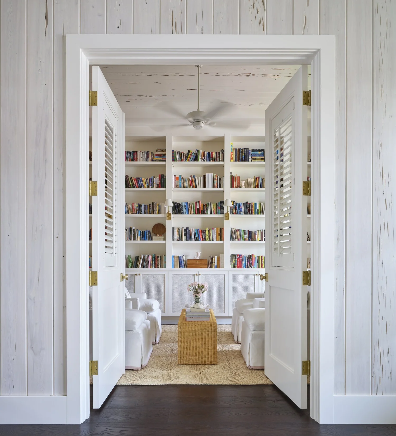 With the right texture, stones, statement lighting, and fabrics, a serene room takes shape. Take a look at warm neutral living room ideas that remain timeless. From layered textures to statement lighting, these designs never go out of style! Kara Miller Interiors | Brantley Photography - love the bookcases in this living room with the 4 white chairs