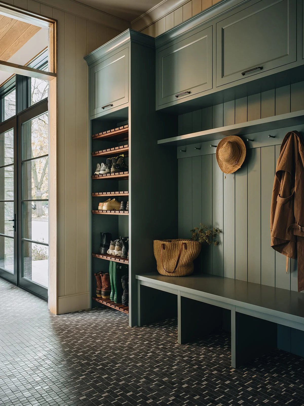 Relax, brew an extra cup of coffee and take a peek at this Jean Stoffer designed mudroom beautifully photographed by Stoffer Photography Interiors, that is so unforgettably chic - love the moody blue