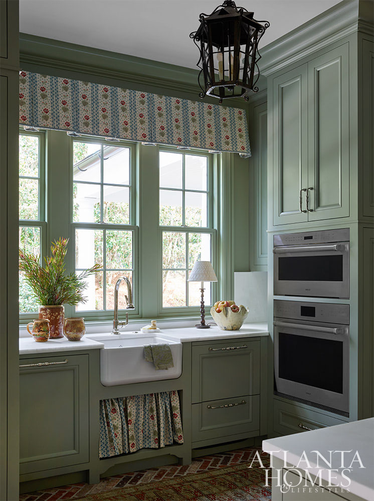 You’re going to love today’s post on the one-of-a-kind home designed by Nancy Izlar.  Known for her livable yet elegant aesthetic, Izlar seamlessly marries the best of both family heirlooms and traditional design elements for a collected style. Every corner of this perfectly styled home in Buckhead has been thoughtfully designed to maximize the breathtaking natural surroundings. With the large windows that let in plenty of natural light, this home combines beauty and comfort. Take a look at this timeless home tour, and we think you'll agree! Source: Atlanta Homes & Lifestyles | Interior Design: Nancy Izlar Interiors | Architect: Caroline Rolader, REU Architects | Builder: Wright Marshall and Greg DeLoach, Revival Construction | Landscape Architect: Land Plus | Photographed by Emily Followill | Styled by Holly Bryan and Erin Haraway - green paint in mudroom