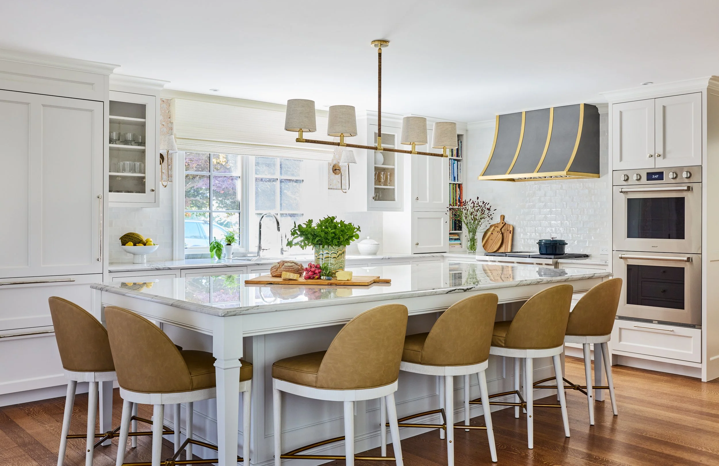 Chic, inviting interiors with just the right amount of personality are hallmarks of this talented designer’s style. Take a break, and take a peek at this beautiful Manchester-by-the-Sea home designed by Honey Collins Interiors. white kitchen design with black range hood