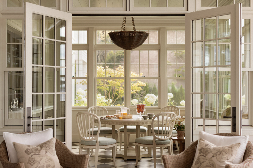 one-of-a-kind place in Lake Washington, designed by the talented Marianne Simon Interior Design, beautifully photographed by Aimee Mazzenga, and styled by Cate Ragan Stylist. - round dining table with a wicker chandelier over the table